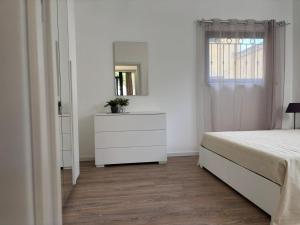a white bedroom with a white dresser and a mirror at SARA - interno 2 - Premium Villas in Giulianova