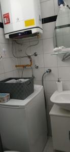 a bathroom with a toilet with a microwave on top of it at Apartman Marcel in Nijemci +4 photos