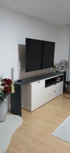 a entertainment center with a television on top of it at Apartman Marcel in Nijemci