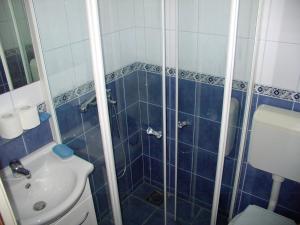 a bathroom with a shower with a toilet and a sink at Pansion Ivan in Sućuraj +87 photos