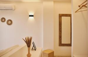 a bathroom with a light on the wall and a mirror at Casa Nature Paestum in Capaccio-Paestum +19 photos
