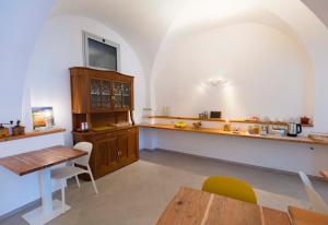 a dining room with a table and a wooden cabinet at CasaCirio Agriturismo in Rialto +46 photos