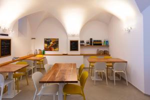 a restaurant with wooden tables and yellow chairs at CasaCirio Agriturismo in Rialto