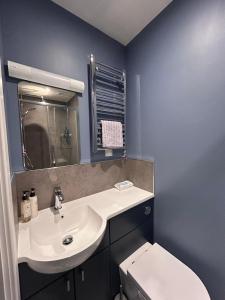 a bathroom with a white sink and a toilet at Gruinard Guest House in Beauly +20 photos