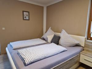 two pillows on a bed in a room at Reiterhof Schmidt, Gaststätte & Pension in Golk +31 photos