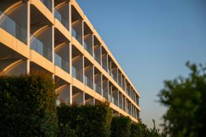 a building with glass windows on the side of it at W Algarve in Albufeira