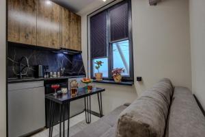 a living room with a couch and a table at EV Hotel Baytik in Verkhnyaya Alaarcha