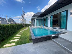 a swimming pool in the backyard of a house at The Casa Del Forest Ao-Nang in Ban Nong Thale