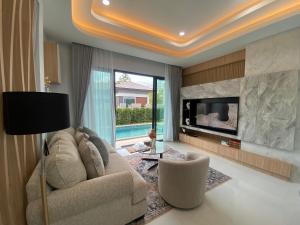 a living room with a couch and a fireplace at The Casa Del Forest Ao-Nang in Ban Nong Thale