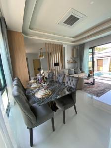 a living room with a table and a couch at The Casa Del Forest Ao-Nang in Ban Nong Thale