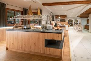 a kitchen with a large island with a counter top at Hotel Mittagskogel Pitztal in Sankt Leonhard im Pitztal