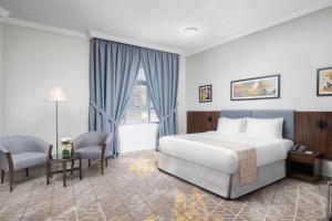 a hotel room with a bed and a window at Elaf Bakkah Hotel in Mecca +93 photos