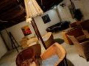 a living room with a lamp and a couch at Happy Villas in Paje