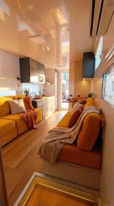 a living room with a bed and a kitchen at Barco Different Charter - Experiencia Única en el Puerto Deportivo de Vigo in Vigo