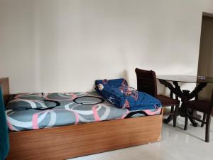 a bed in a room with a table and a table at Prolife Tathwade in Méribel Village +8 photos