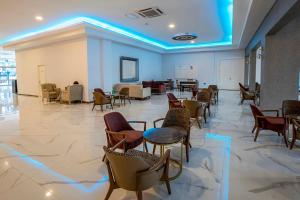 a lobby with chairs and tables in a building at Alder Garden Resort -Ultra All Inclusive in Kemer