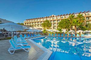 a hotel with a pool and chairs and a building at Alder Garden Resort -Ultra All Inclusive in Kemer