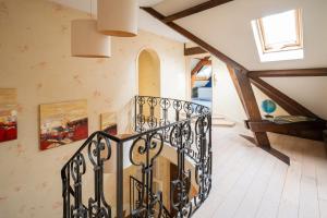 a staircase in a house with a stair railing at Maison Le Reflet de Marne - Welkeys in Vaires-sur-Marne