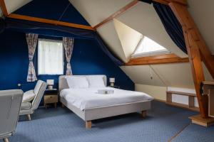a bedroom with a bed and a chair in a room at Maison Le Reflet de Marne - Welkeys in Vaires-sur-Marne