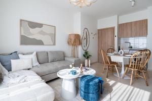 a living room with a couch and a table at Compass 1-BR Apartment by Makenzy Beach in Larnaca