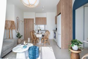 a living room with a couch and a table at Compass 1-BR Apartment by Makenzy Beach in Larnaca +9 photos
