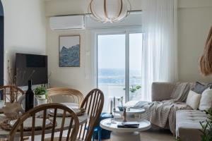 a living room with a table and chairs at Compass 1-BR Apartment by Makenzy Beach in Larnaca