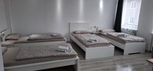 a room with three beds and a window at Goldberg Apartments in Kassel