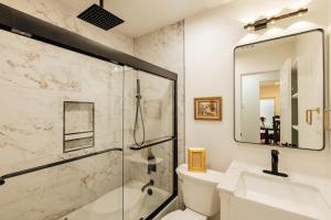 a bathroom with a shower and a toilet and a sink at Extended Stay SoCo Oasis Outdoor TV, Heavenly Bed, Long Stay Ready in Austin +34 photos