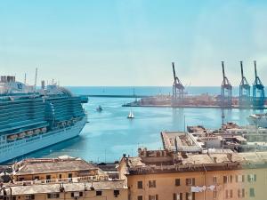 a cruise ship is docked next to a harbor at B&B Luci del porto in Genoa