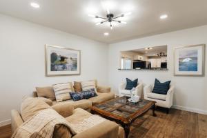 a living room with a couch and a table at Extended Stay SoCo Oasis Outdoor TV, Heavenly Bed, Long Stay Ready in Austin