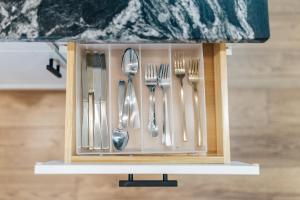 a utensil holder with forks and spoons at Extended Stay SoCo Oasis Outdoor TV, Heavenly Bed, Long Stay Ready in Austin