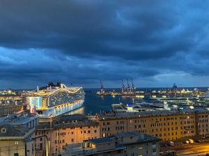 a cruise ship docked in a harbor at night at B&B Luci del porto in Genoa