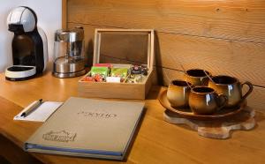 a table with three tea cups and a box on it at Vila Emma in Štrbské Pleso