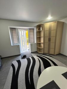 a room with a zebra rug and a table at Apartament Edinet in Edineţ