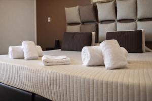 a bed with white towels on top of it at Hotiday Firenze Vespucci in Florence