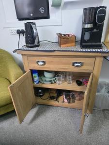 a wooden table with a tv on top of it at Tor's Place in Portree