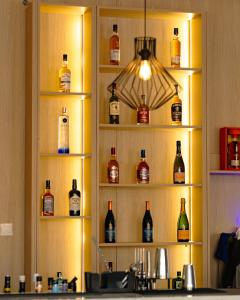 a shelf filled with lots of bottles of alcohol at Atlanticblu hotels & Resort in Abuja