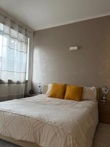 a bedroom with a bed with two yellow pillows at Posticino apartment in Soave