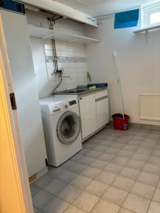 a laundry room with a washing machine in it at Chilla villa in Leryd