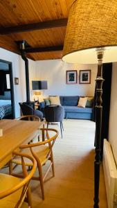 a living room with a blue couch and a table at Coeur de bois - 19 in Petit Mesnil