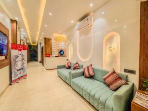 a living room with a green couch in a store at Zip by Spree Hotels R Group Kota - Near Coaching Hub & Oxy Park in Kota