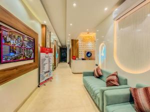 a living room with a green couch in a store at Zip by Spree Hotels R Group Kota - Near Coaching Hub & Oxy Park in Kota