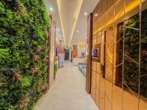 a hallway in a store with plants on the walls at Zip by Spree Hotels R Group Kota - Near Coaching Hub & Oxy Park in Kota
