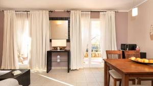 a living room with a table and a dining room at Appartment house Zara in Brzac