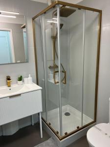 a bathroom with a glass shower and a sink at One minute to the Beach in Menton +53 photos