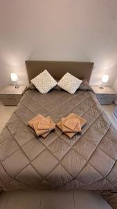 a large bed with two pillows on top of it at One minute to the Beach in Menton