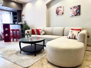 a living room with a couch and a table at Deluxe Apartment Partial Nile View in Cairo