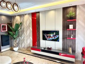a living room with a tv on a wall at Deluxe Apartment Partial Nile View in Cairo +70 photos