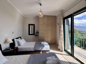 a bedroom with a bed and a balcony at Villa Yianna in Karavádhos