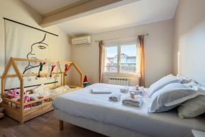 a bedroom with a bed with a baby in it at Maison Flammarion - Welkeys in Avignon